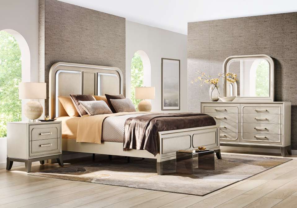 Bedroom furniture set with a bed, nightstand, dresser, and mirror.
