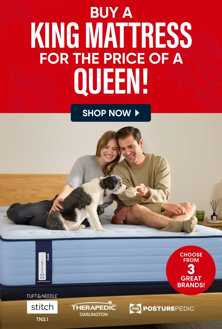 Buy a King mattress for the price of a Queen. A couple and their dog sit on a mattress, featuring Tuft & Needle, Sealy.