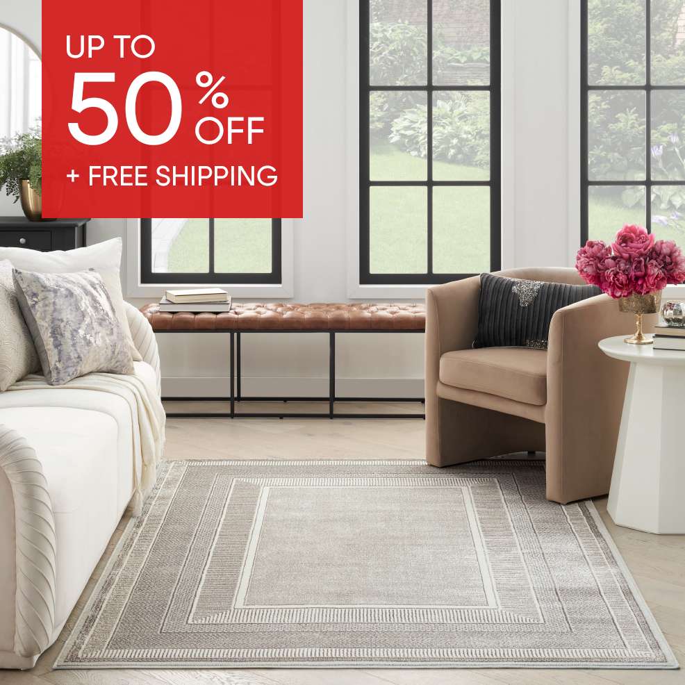 UP TO 50% OFF + FREE SHIPPING. Interior of a living room with a rug.