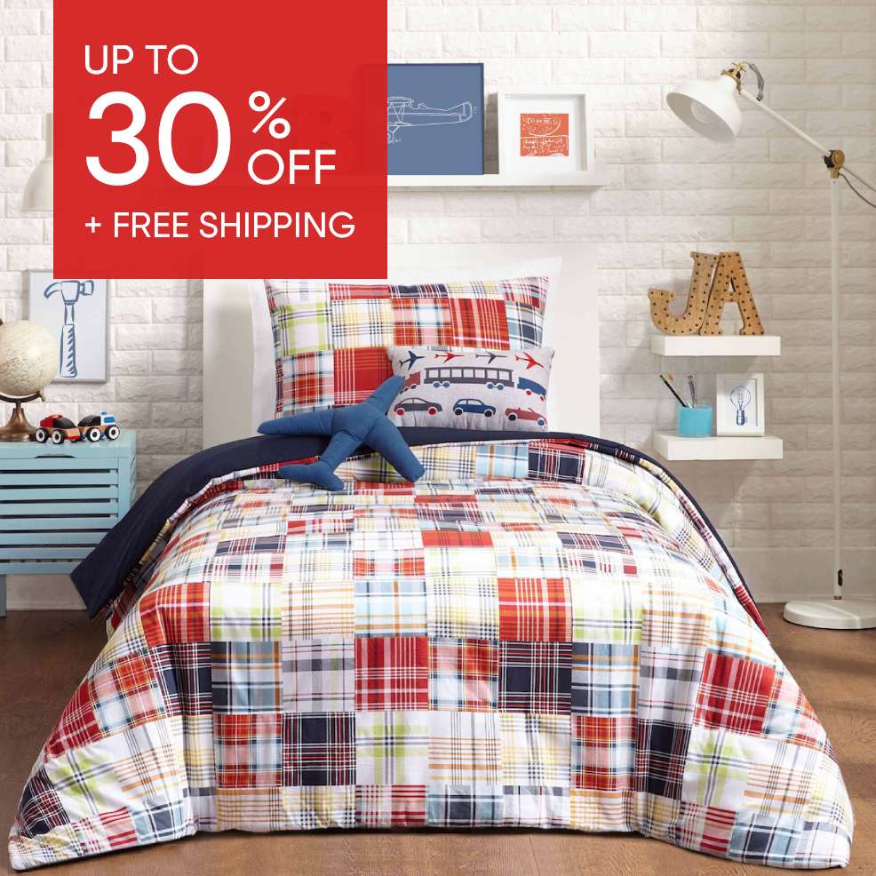 Up to 30% off + Free Shipping. A bed with a patchwork quilt and airplane-themed pillows.