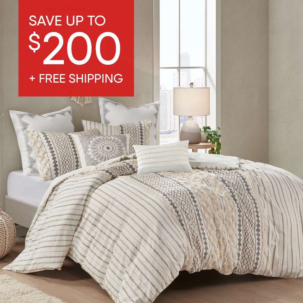 SAVE UP TO $200 + FREE SHIPPING. A bed with a patterned comforter and pillows.