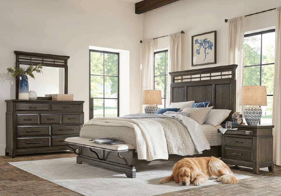 Bedroom furniture set with a bed, dresser, nightstand, and a dog.
