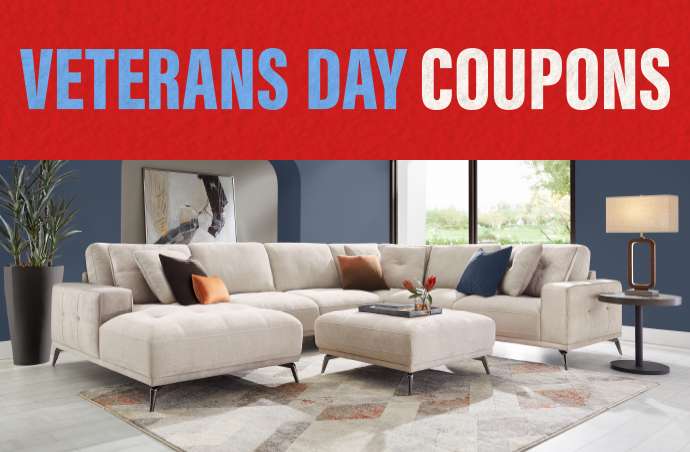 VETERANS DAY COUPONS. A sectional sofa with an ottoman in a living room.
