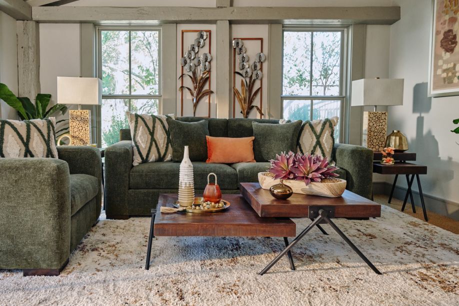 Living room with green sofa, armchairs, and coffee table.
