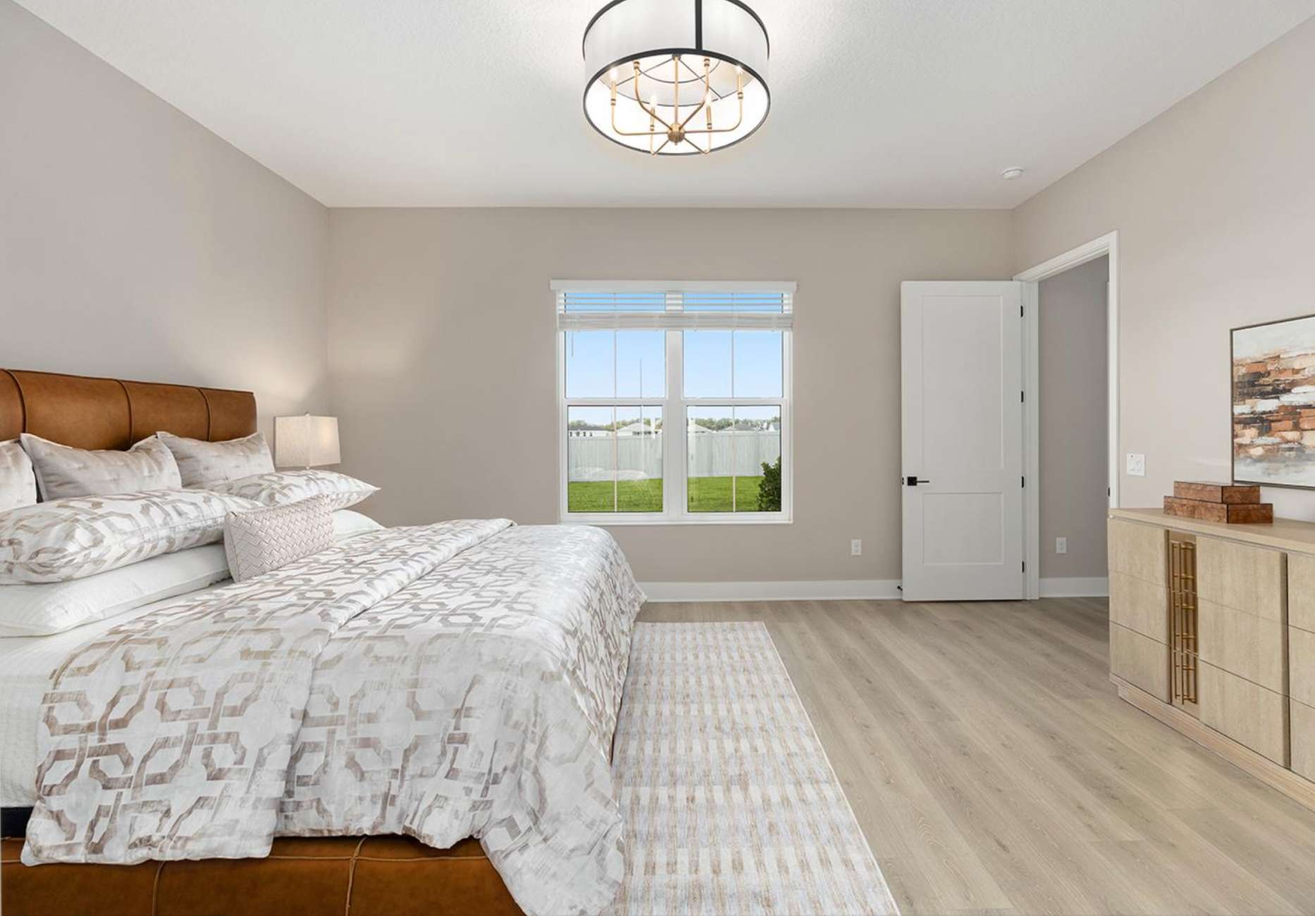 Bedroom with a bed, rug, and dresser.
