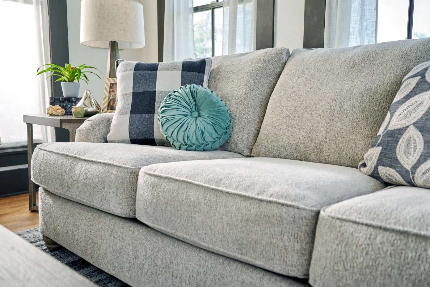 Light gray sofa with decorative pillows.

