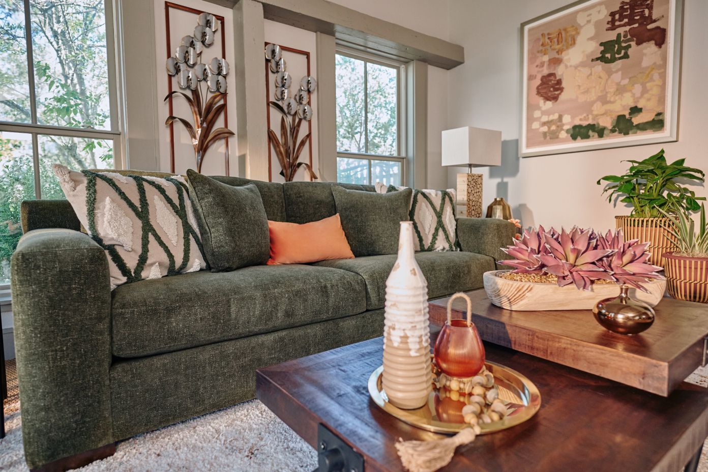 green shofa with tan and green cushions