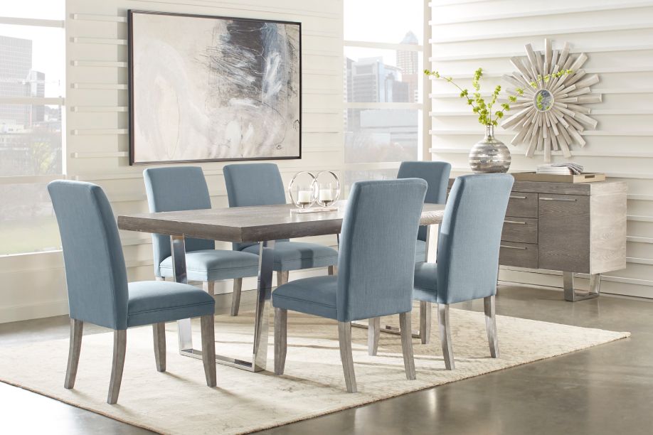 Dining room set with a gray table, blue chairs, and a gray sideboard.
