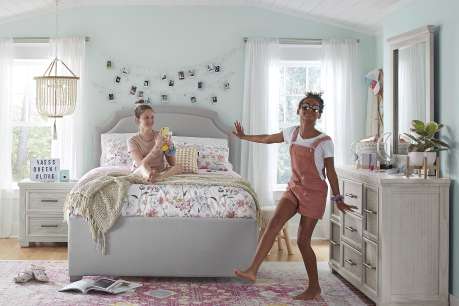 girls on a bed in a room 