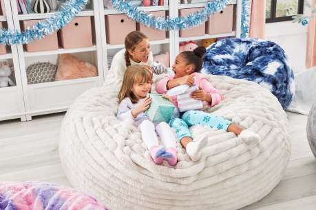 kids play on a bean bag and reading 