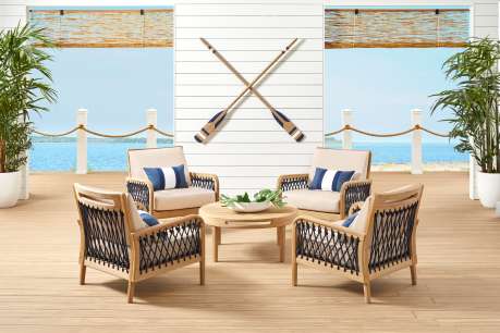 four chair patio set with table in the middle