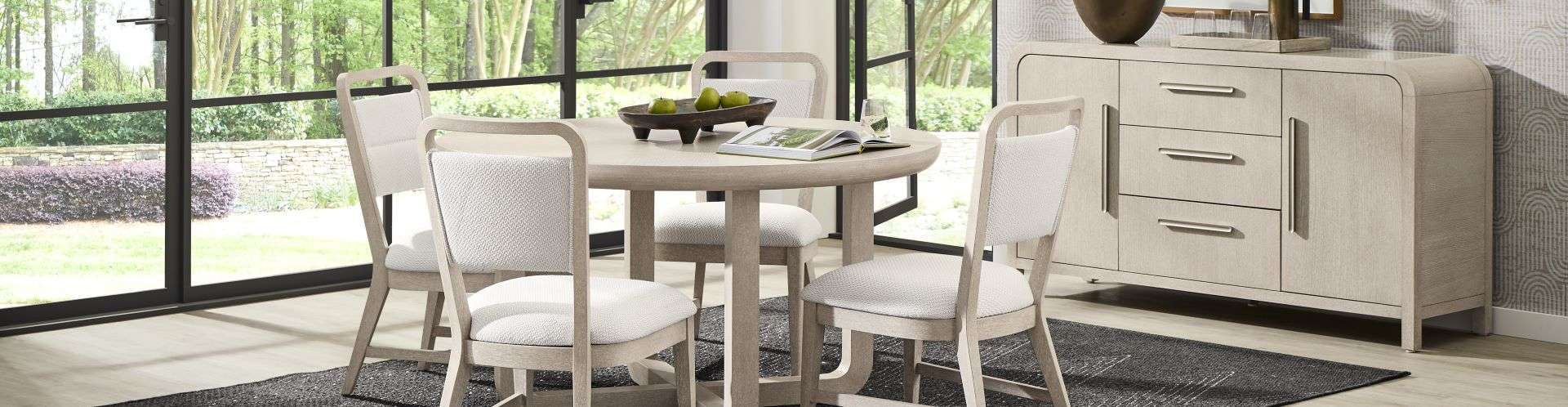 Dining room set with a round table, chairs, and a sideboard.
