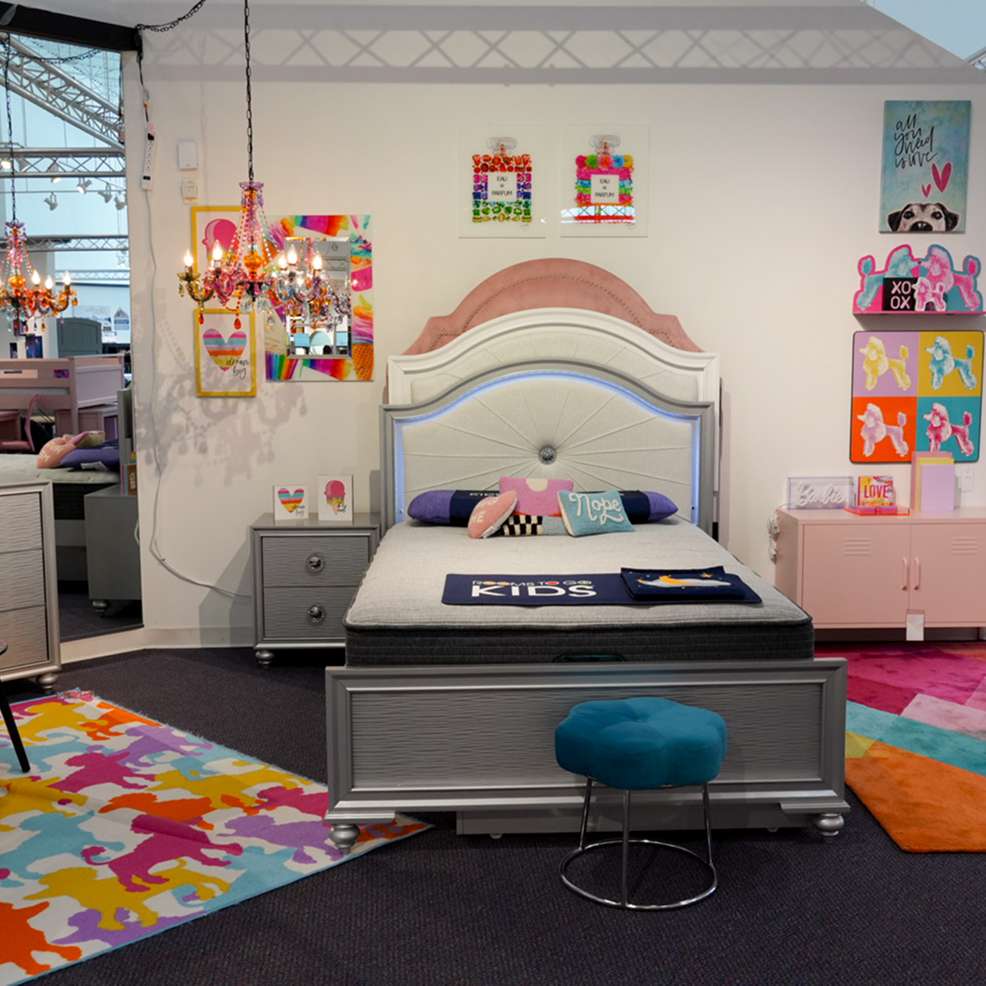 A bedroom set with a bed, nightstand, and colorful decor.
