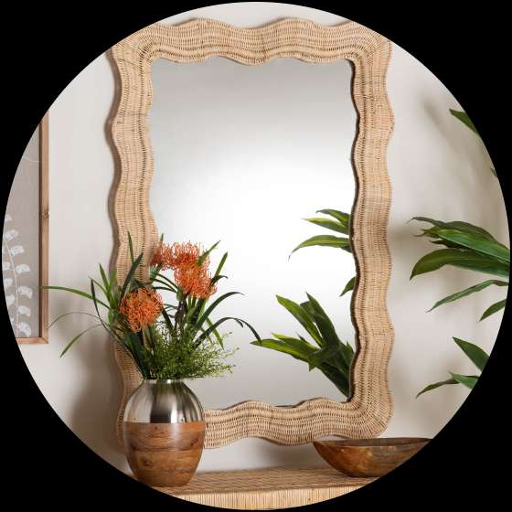 Wicker framed mirror with a wavy edge.
