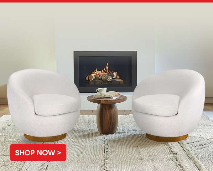 SHOP NOW > Two white swivel chairs with a small wooden table in front of a fireplace.
