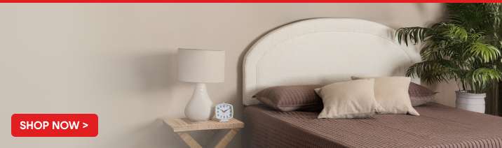SHOP NOW > Bed with pillows and a lamp.
