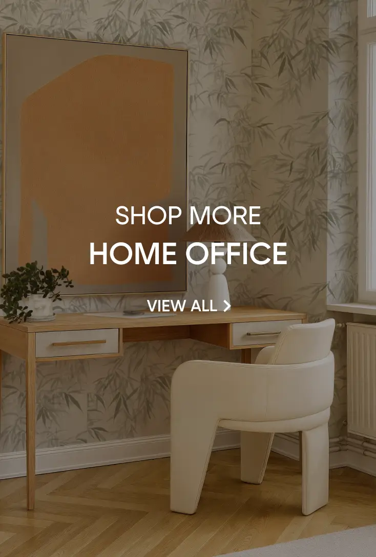 SHOP MORE HOME OFFICE VIEW ALL. A modern home office featuring a wooden desk, a cream-colored chair, and abstract art.