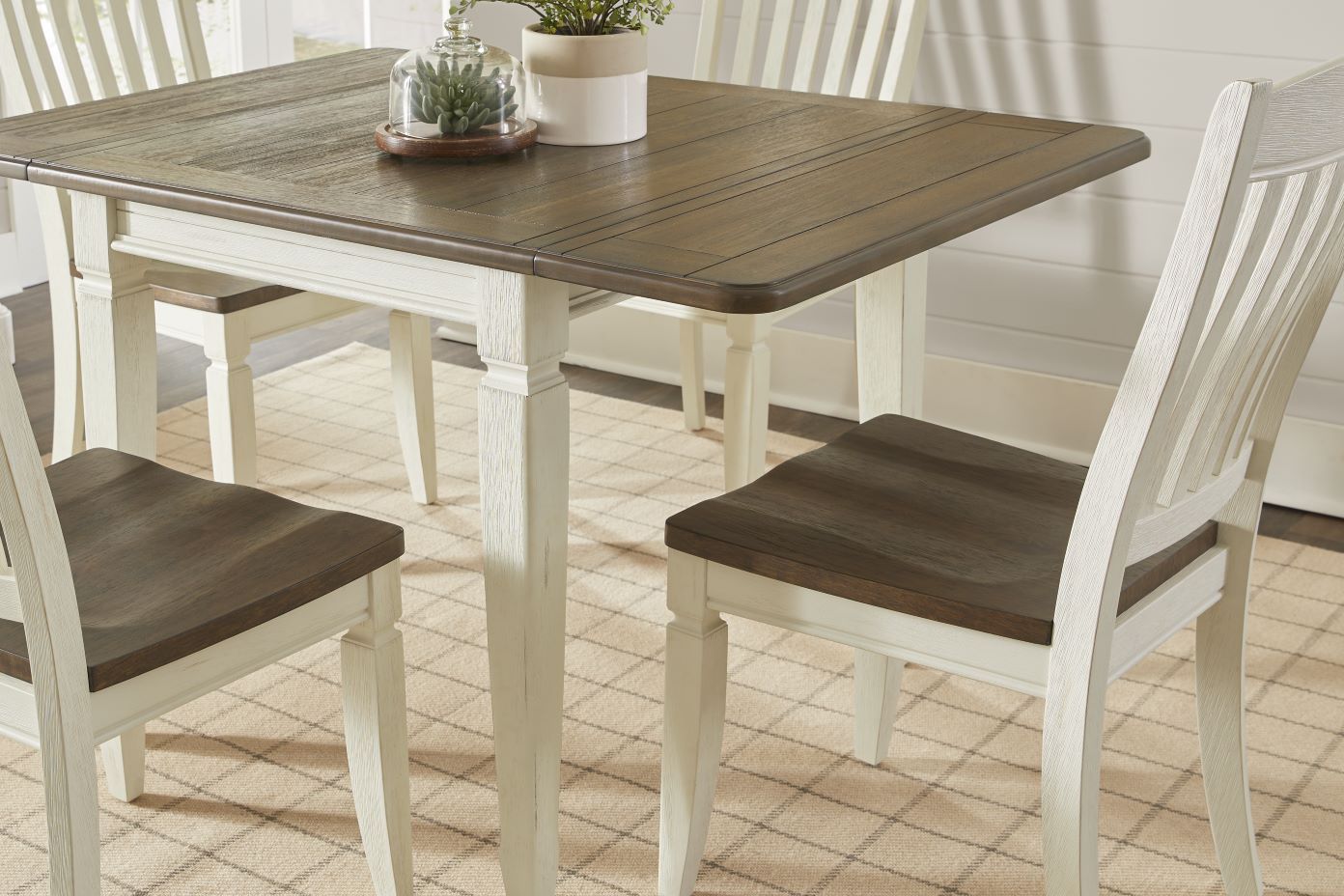 Dining table and chairs with a two-tone finish.
