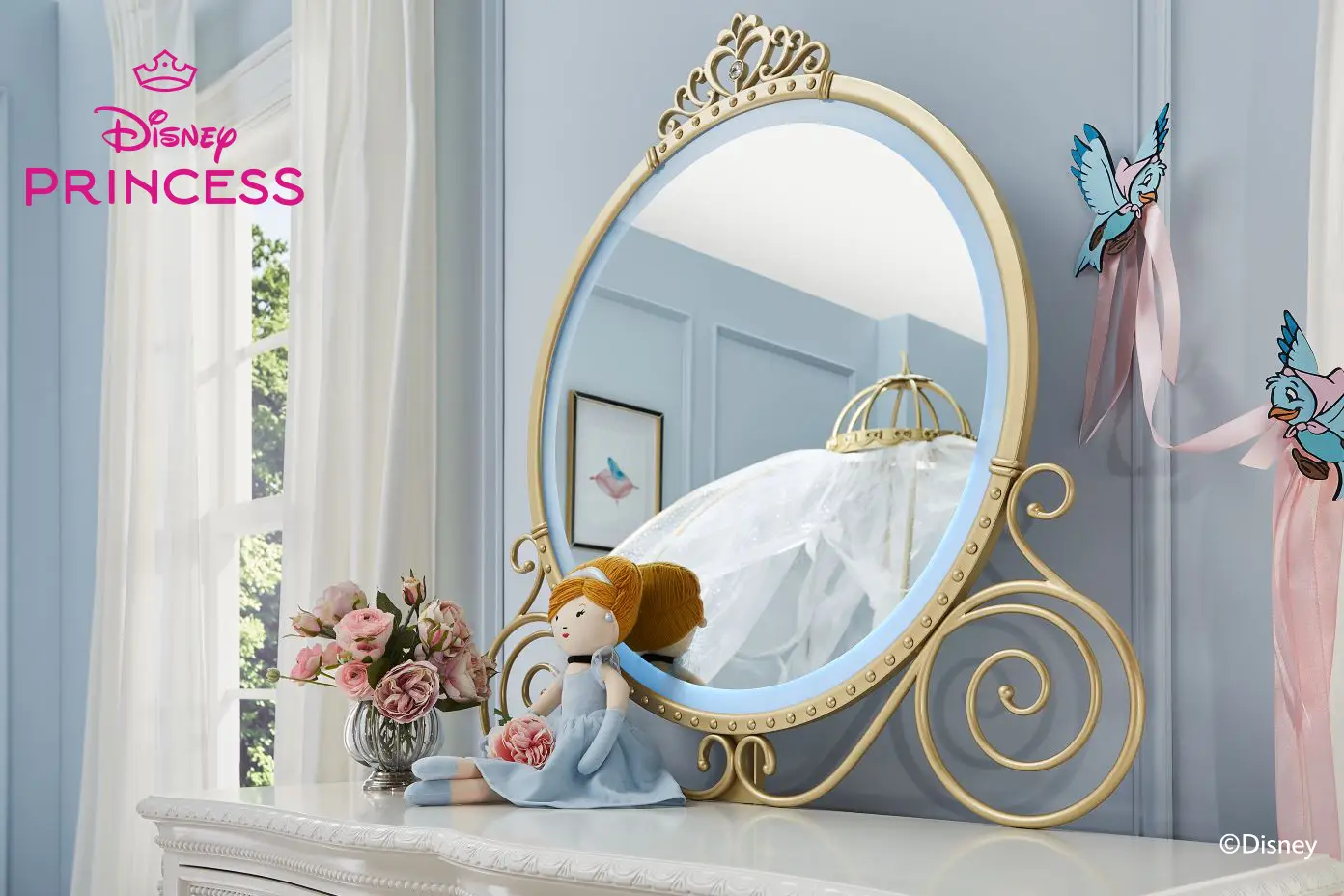 Disney Princess. A gold-framed mirror with a crown, a doll, and bird decorations.
