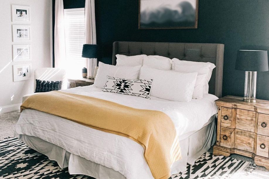 Bedroom with a bed, nightstands, and a rug.
