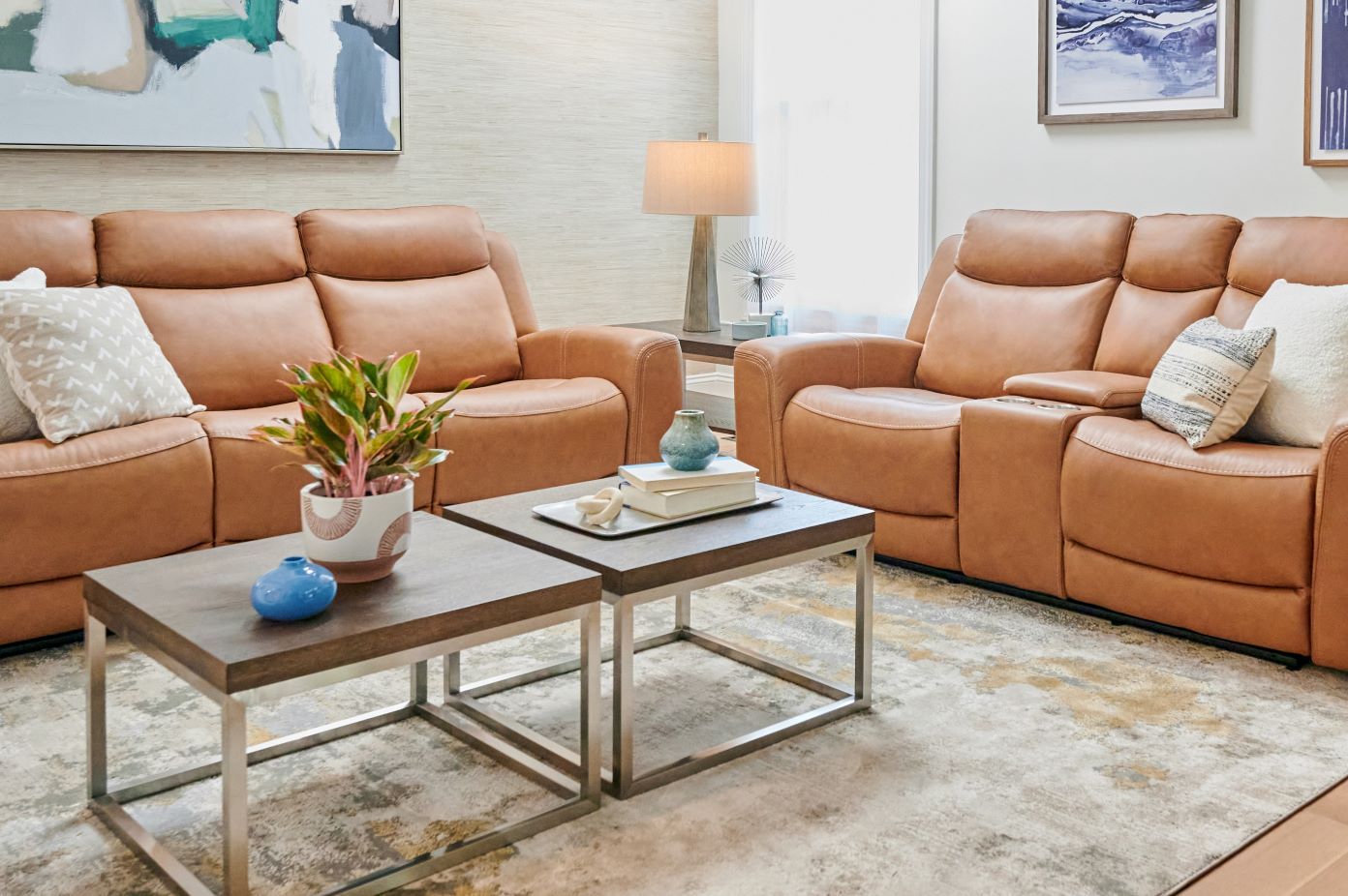Two brown leather recliners with a coffee table and a rug.
