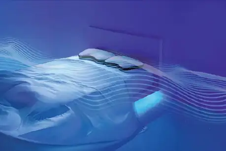 Bed with blue sheets and pillows.
