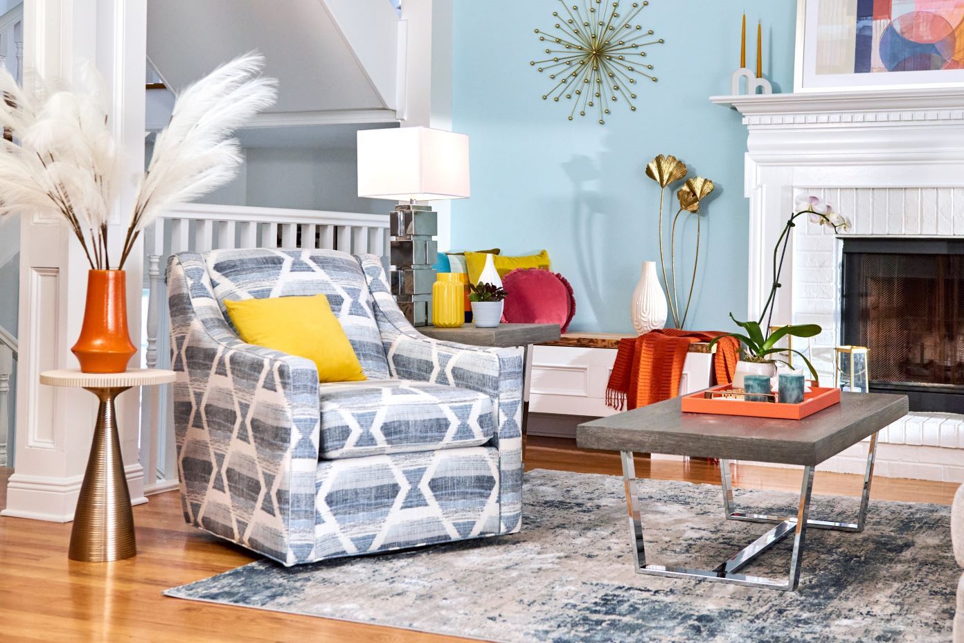 Living room with a patterned armchair, coffee table, and fireplace.
