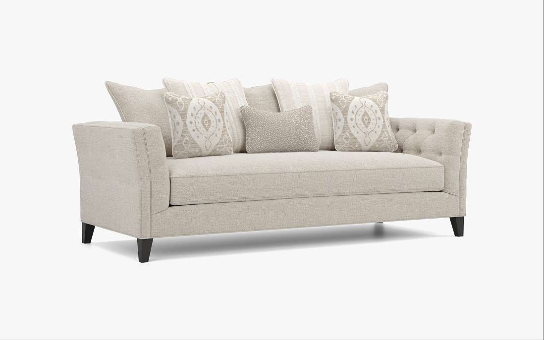 Beige sofa with decorative pillows.
