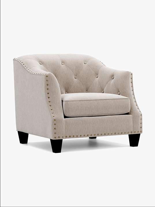 Beige upholstered armchair with black legs.
