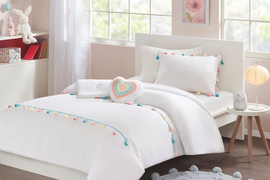 white bedspread with pom pom