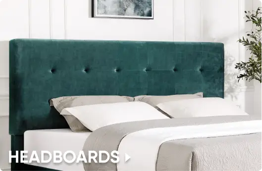 HEADBOARDS. A teal velvet tufted headboard behind a bed with white and grey bedding.