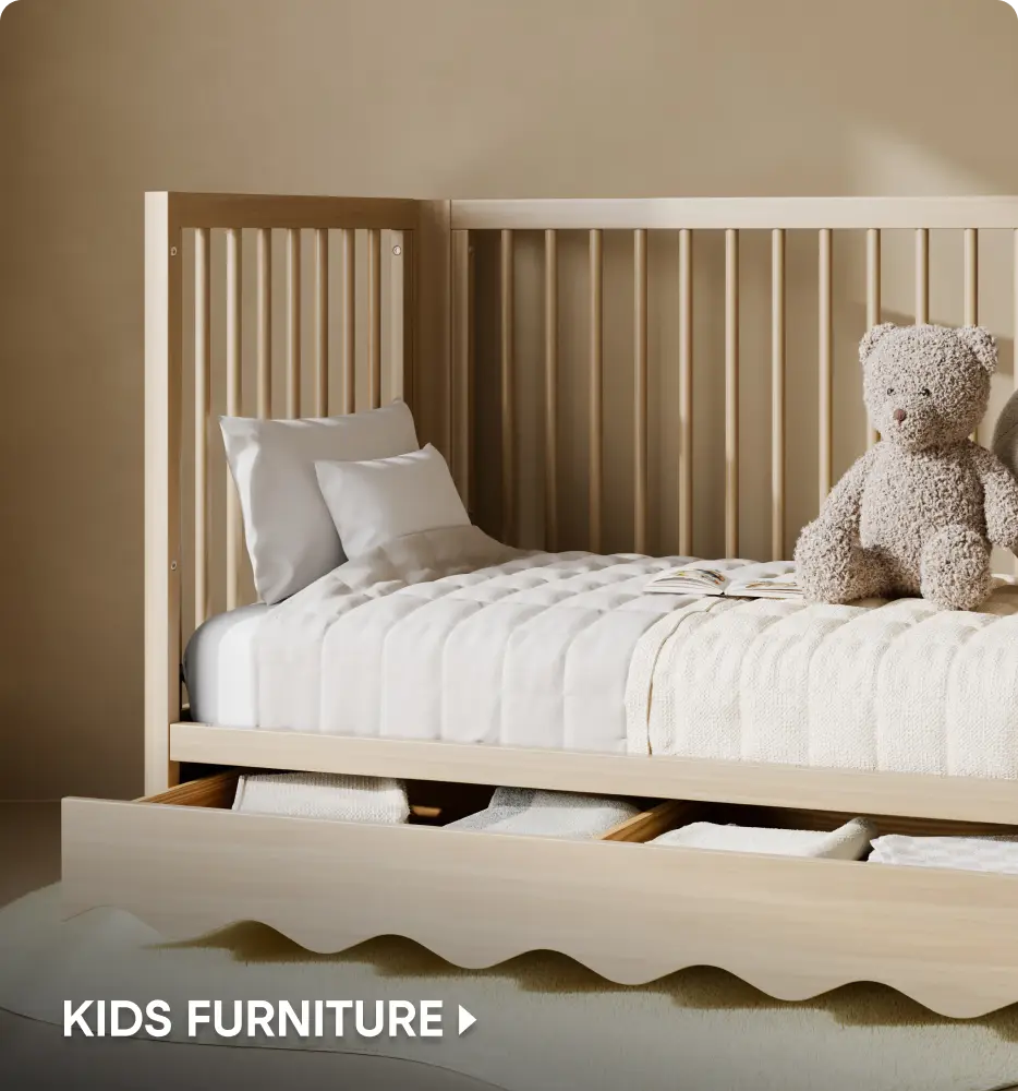 KIDS FURNITURE: A light wood toddler bed with a scalloped storage drawer and a teddy bear sitting on the mattress.