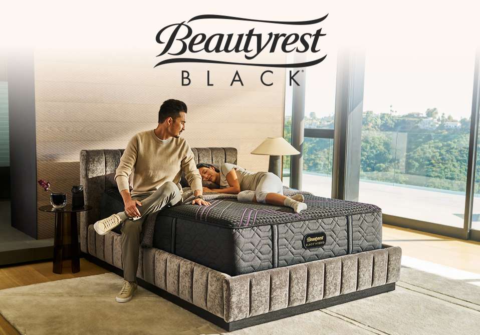 Beautyrest BLACK. A man and woman are on a bed.
