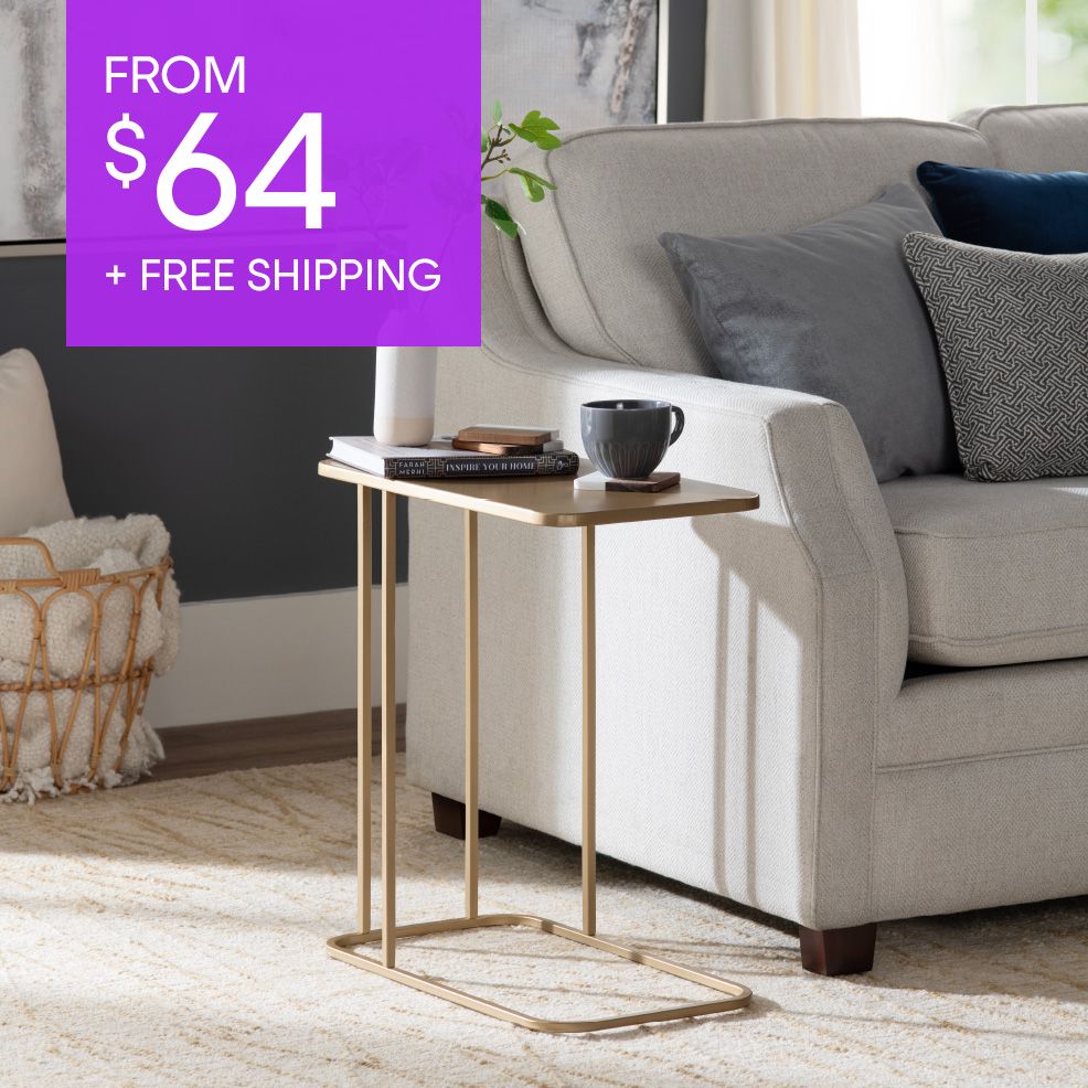 FROM $64 + FREE SHIPPING. A gold side table next to a light-colored couch.
