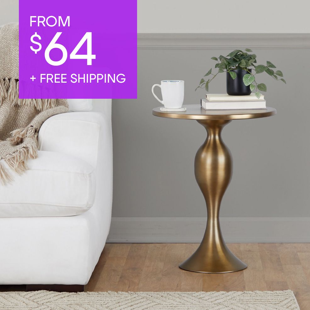 FROM $64 + FREE SHIPPING. A gold side table with a plant, books, and a mug.
