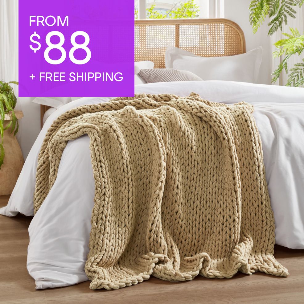 FROM $88 + FREE SHIPPING. A beige chunky knit blanket on a bed.
