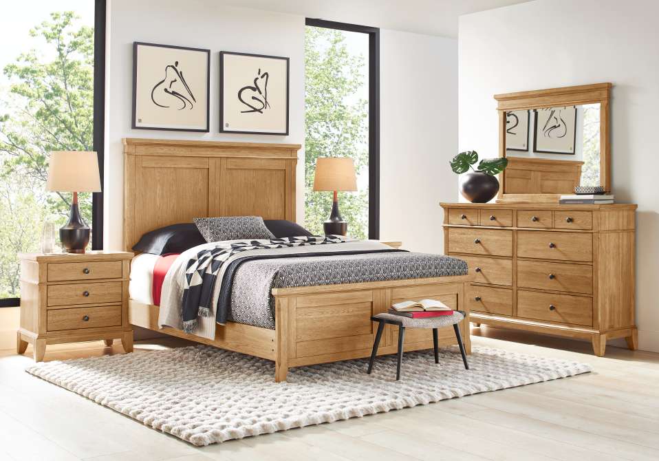Bedroom furniture set with a bed, nightstands, dresser, and mirror.
