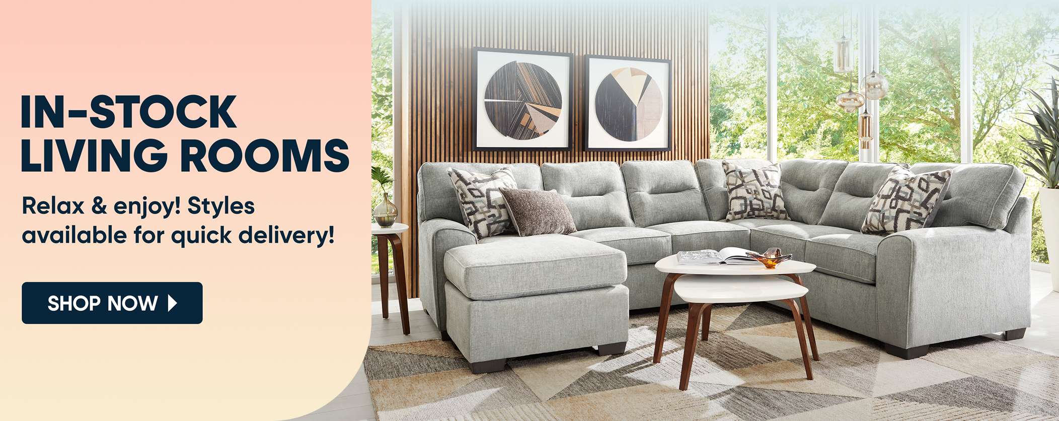 IN-STOCK LIVING ROOMS. A gray sectional sofa in a living room.
