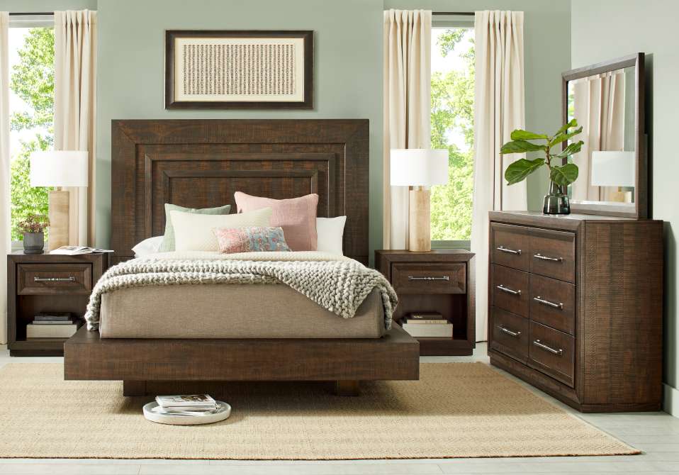Bedroom furniture set with a bed, nightstands, and dresser.
