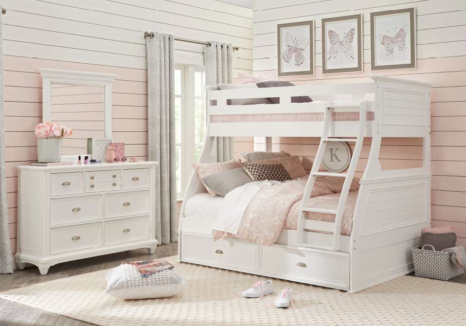 White bunk bed with a dresser and butterfly artwork.
