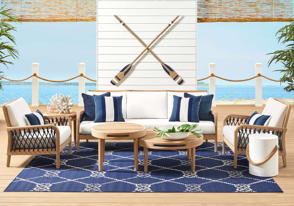 Outdoor furniture set with blue and white nautical theme.
