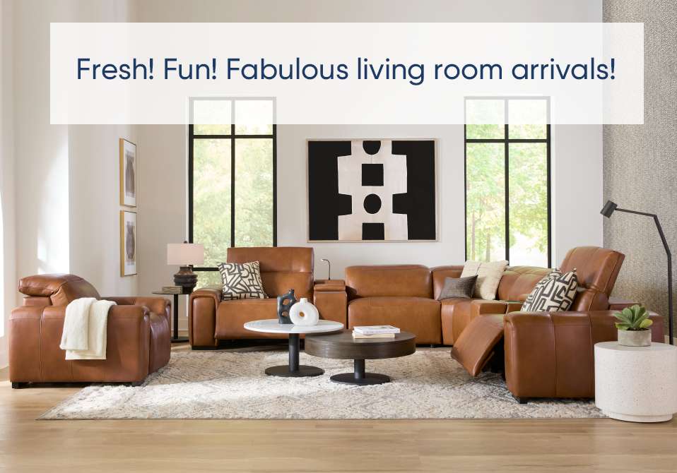 Fresh! Fun! Fabulous living room arrivals! A living room with brown leather furniture.
