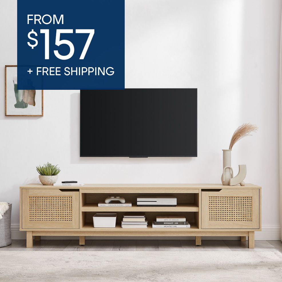 FROM $157 + FREE SHIPPING. A light wood TV stand with a TV mounted above it.
