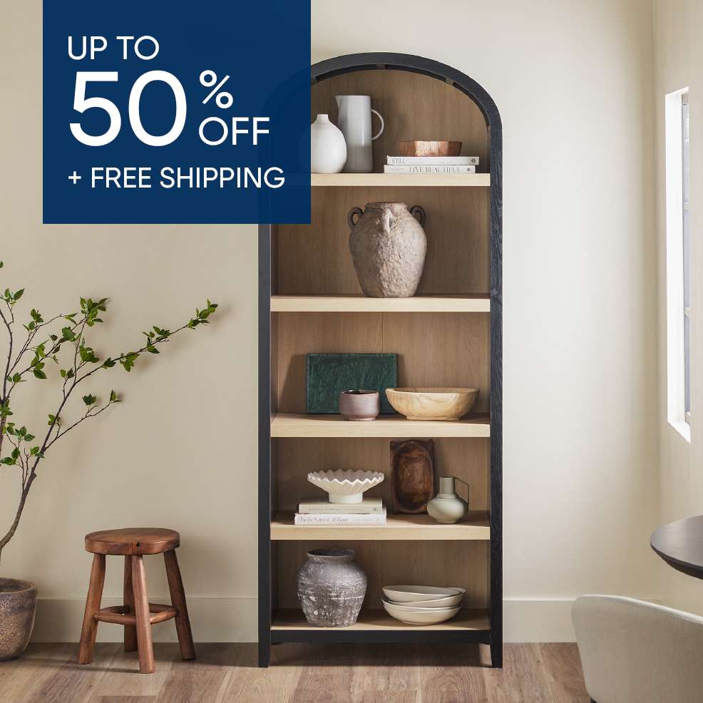 UP TO 50% OFF + FREE SHIPPING. A tall wooden bookshelf with decorative items.
