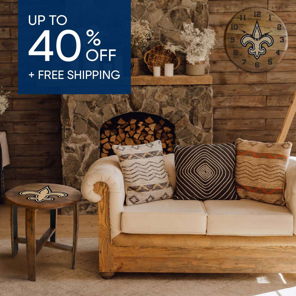 Up to 40% off + free shipping. A living room with a couch, pillows, and a table with a Saints logo.

