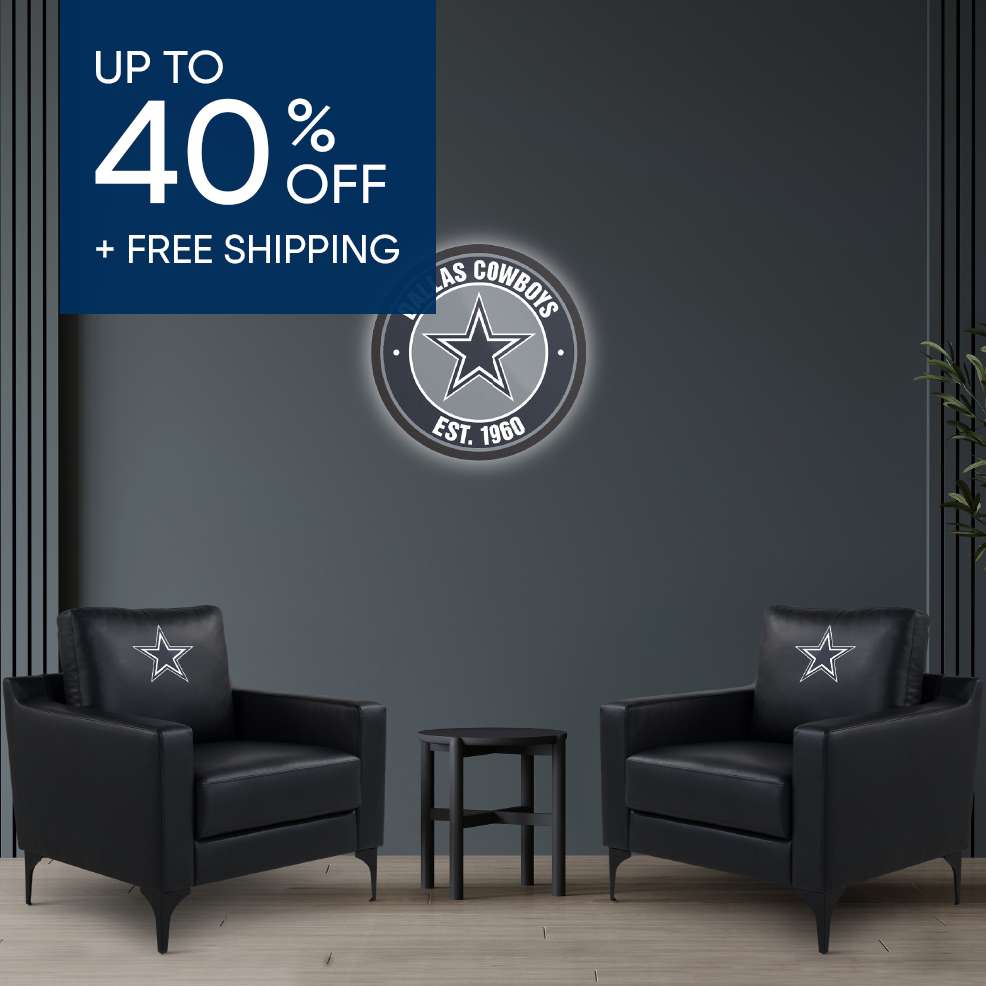 Up to 40% off + free shipping. Two black armchairs with Dallas Cowboys logo pillows, a side table, and a Cowboys sign.

