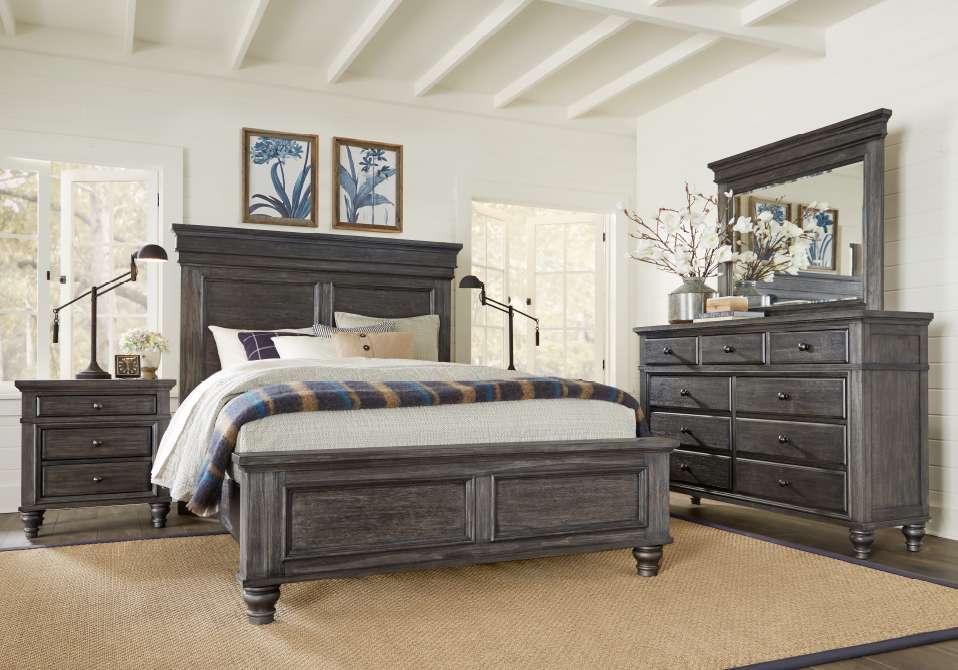 Bedroom furniture set with a bed, nightstand, and dresser.
