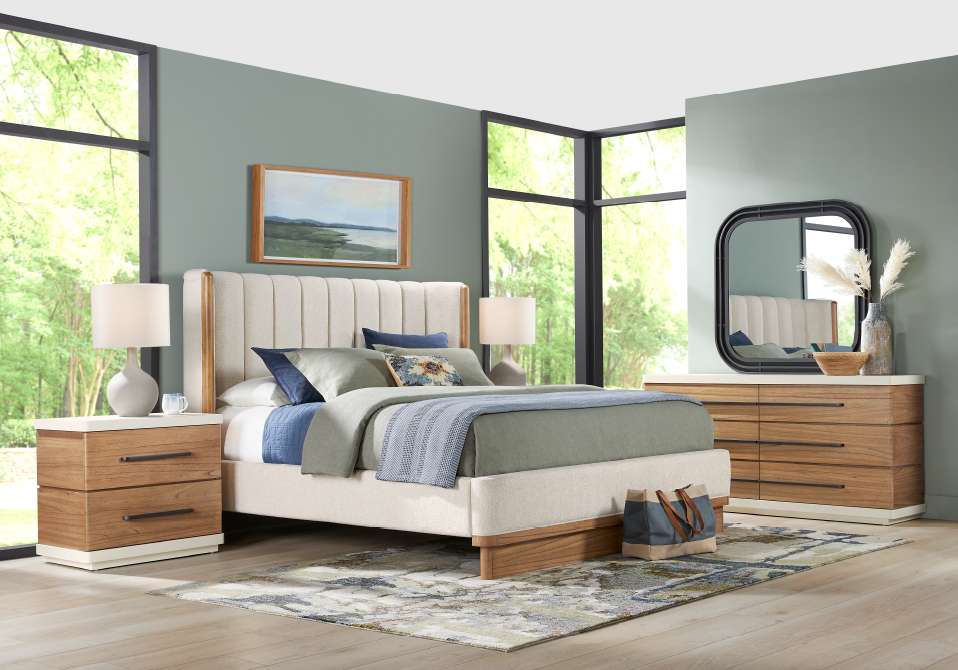 Bedroom furniture set with a bed, nightstands, dresser, and mirror.
