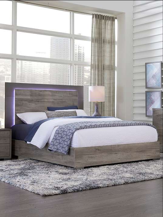 Bedroom set with a bed, nightstand, and rug.
