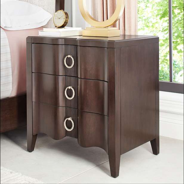Dark brown nightstand with three drawers and ring pulls.
